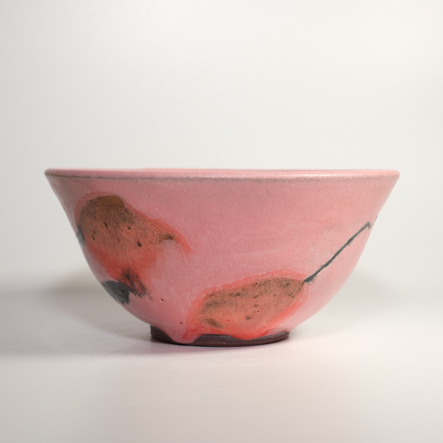 Bright Orange and Black Flower on Pink Bowl