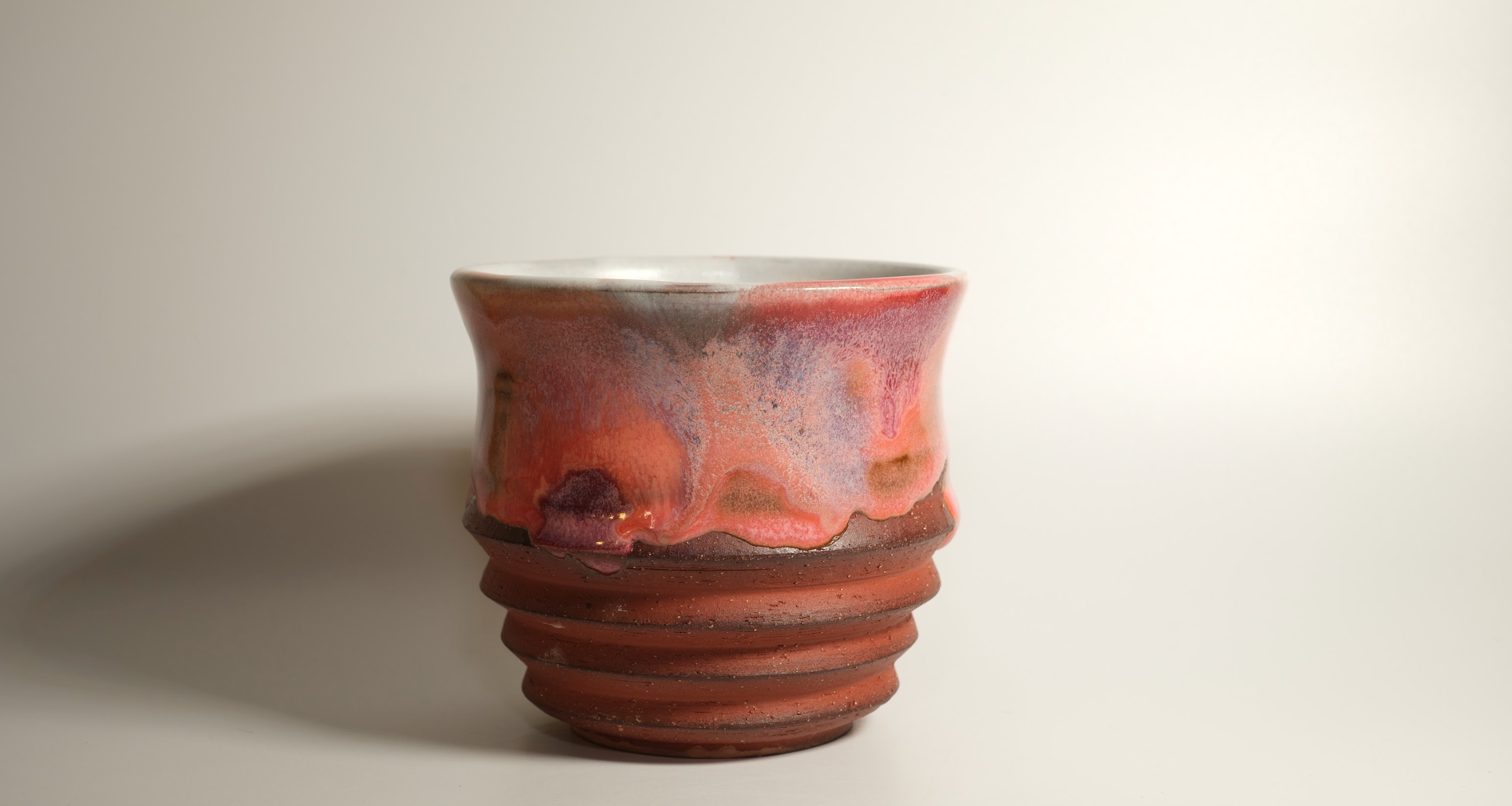 wheel thrown carved pink and orange cup